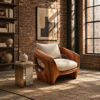 Sculpted wooden shell chair with an oval side opening and cream cushions in an industrial loft living room with exposed brick