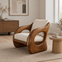 Lounge chair with a thick sculpted wood shell and oval side openings in a Scandinavian living room with white walls