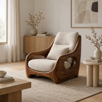 Sculpted lounge chair with oval side cutouts and a cushioned seat in a Scandinavian living room with white walls