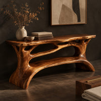 Corner detail of shoe bench with a slab top, root style supports and an open shelf beside wood, brass and linen samples