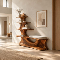 Sculpted wood shoe bench with a cushioned seat and a tower of shelves in a bright open plan entryway