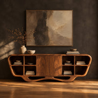 Sculpted sideboard with open cubbies and a flowing wave base in a dark studio against a charcoal plaster wall