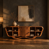 Sculpted sideboard with open cubbies and a flowing wave base in a dark dining room at golden hour
