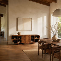 Sculpted sideboard with open cubbies and a flowing wave base in a bright open plan dining room