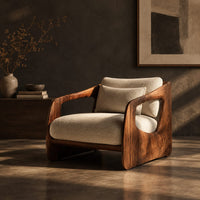 Chair with thick sculpted wooden side panels, oval cutouts and a cushioned seat, three-quarter view showing the grain