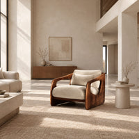 Chair with thick sculpted wooden side panels, oval cutouts and a cushioned seat in a bright open plan living room