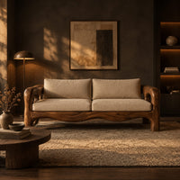 Sculpted wood sofa with open loop arms and a wavy lower rail in a dark living room at golden hour