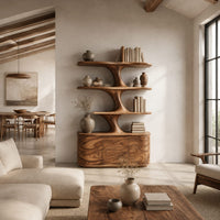 Bookshelf with wavy shelves on a sculpted stem and a three door base in a bright open plan living room