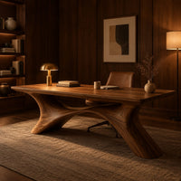 Desk with a plank top on two sweeping legs joined by an arch in an evening home office with walnut wall paneling