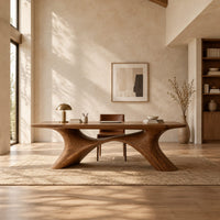 Desk with a plank top on two sweeping legs joined by an arch in a bright open plan home office