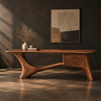 Long desk with sculpted swooping legs and a two drawer unit under the top, three-quarter view showing the grain