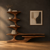 Sculpted tv stand with a stacked shelf tower and a long low ledge in a dark studio against a charcoal plaster wall