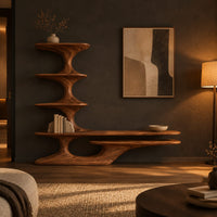 Sculpted tv stand with a stacked shelf tower and a long low ledge in a dark living room at golden hour