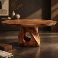 Corner detail of dining table with a twisted pedestal base and a softly waved edge top beside wood, brass and linen samples