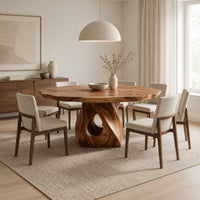 Dining table with a twisted pedestal base and a softly waved edge top in a Scandinavian dining room with white walls