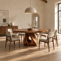 Dining table with a twisted pedestal base and a softly waved edge top in a bright open plan dining room