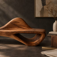 Corner detail of low bench with a raised wave at one end and an open loop base beside wood, brass and linen samples