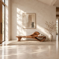 Low bench with a raised wave at one end and an open loop base in a bright open plan entryway
