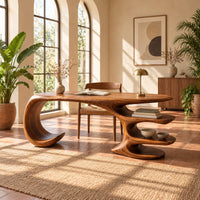 Desk with a large curled leg and stacked shelf tiers at the opposite end in a bright home office with arched windows and plants