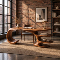 Desk with a large curled leg and stacked shelf tiers at the opposite end in an industrial loft home office with exposed brick