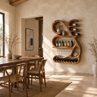 Sculpted wine rack with a looping frame, glass rail and bottle arms in a bright open plan dining room