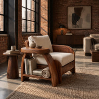 Sculpted wood chair with an oval arm ledge and a cream seat cushion in an industrial loft living room with exposed brick