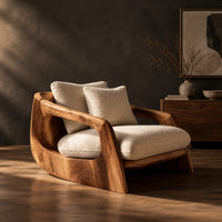 Lounge chair with a sculpted wood shell and thick cream cushions, three-quarter view showing the grain