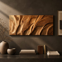 Detail of wooden wall art panel with flowing carved ridges beside wood, brass and linen samples