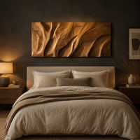 Wooden wall art panel with flowing carved ridges above a bed in a dusk lit bedroom