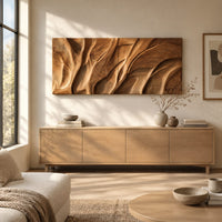 Wooden wall art panel with flowing carved ridges above a light oak sideboard in daylight