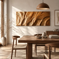 Wooden wall art panel with flowing carved ridges beside a dining table in natural light