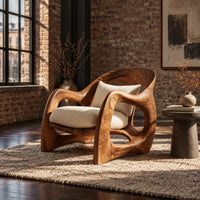 Sculptural wooden chair with looping arms and teardrop side openings in an industrial loft living room with exposed brick