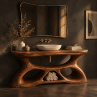 Vanity with a flowing oval top and a sculpted base pierced by smooth openings, three-quarter view showing the grain