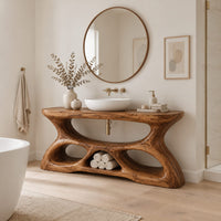 Vanity with a flowing oval top and a sculpted base pierced by smooth openings in a Scandinavian bathroom with white walls
