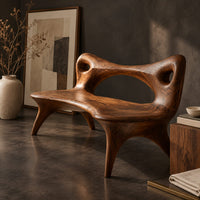 Corner detail of bench with an open loop backrest and four splayed legs beside wood, brass and linen samples