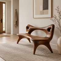 Bench with an open loop backrest and four splayed legs in a Scandinavian entryway with white walls