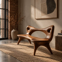 Bench with an open loop backrest and four splayed legs in an industrial loft entryway with exposed brick
