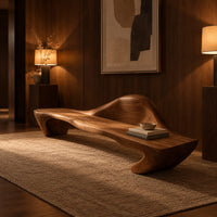 Long wooden bench with a raised wave shaped backrest and curved legs in an evening entryway with walnut wall paneling
