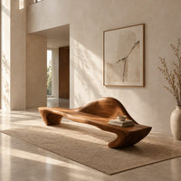 Long wooden bench with a raised wave shaped backrest and curved legs in a bright open plan entryway