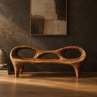 Wooden bench with a low backrest cut with two oval openings on tapered legs in a dark studio against a charcoal plaster wall