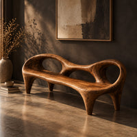 Wooden bench with a low backrest cut with two oval openings on tapered legs, three-quarter view showing the grain