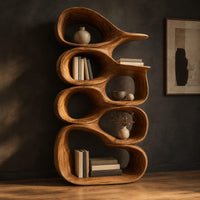 Tall bookshelf made of stacked open wooden cells with a pointed top, three-quarter view showing the grain
