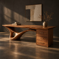 Sculptural desk with a looping wave leg and a three drawer pedestal, three-quarter view showing the grain
