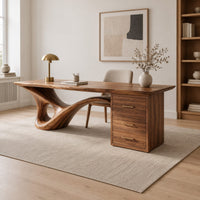 Sculptural desk with a looping wave leg and a three drawer pedestal in a Scandinavian home office with white walls