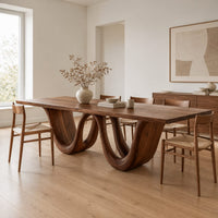 Rectangular dining table on a wavy ribbon base in a Scandinavian dining room with white walls