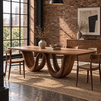 Rectangular dining table on a wavy ribbon base in an industrial loft dining room with exposed brick