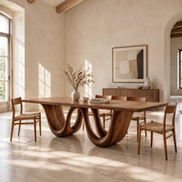 Rectangular dining table on a wavy ribbon base in a bright open plan dining room