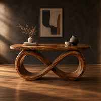 Desk with a figure eight loop base and rounded top in a dark studio against a charcoal plaster wall