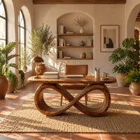Desk with a figure eight loop base and rounded top in a bright home office with arched windows and plants