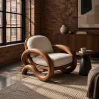 Lounge chair with thick looping arms and curved feet in an industrial loft living room with exposed brick